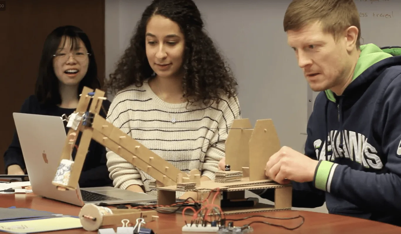 Science teacher testing the early ElectroCrane prototype, operating the crane arm during a usability study