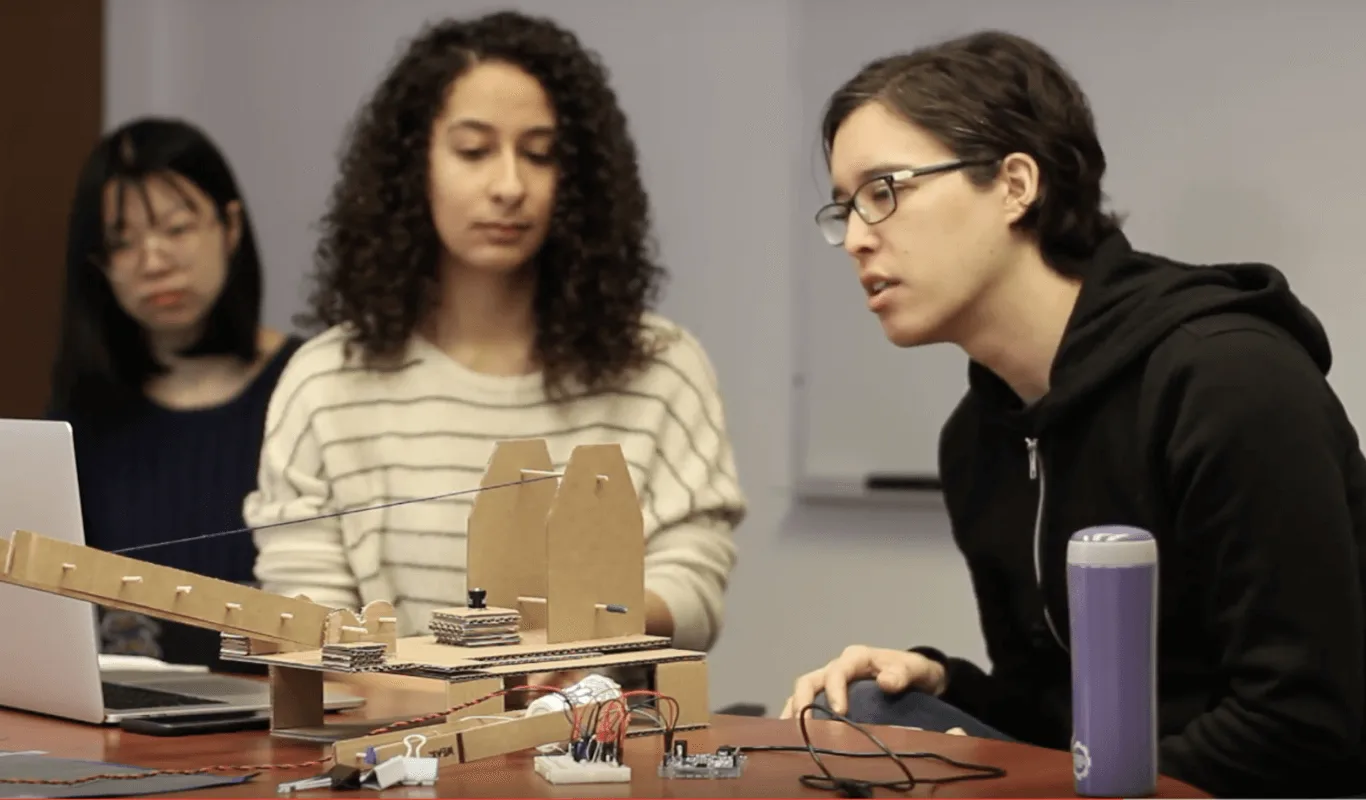 Usability testing session highlighting the split-attention issue: a participant switching between the crane controls and the laptop interface