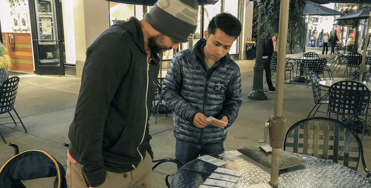 Usability testing session with a participant reviewing Juneau paper prototypes on a table